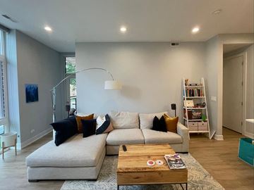 Des Plaines apartment for rent - A living room with a white couch and a wooden coffee table.