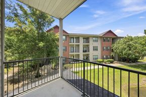 Lafayette apartment for rent - A balcony overlooks a grassy area and apartment buildings.