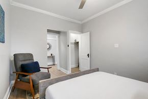 Chicago apartment for rent - a bedroom with a bed and a chair and a door to a bathroom