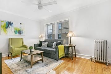 Chicago apartment for rent - a living room with a couch and a chair and a ceiling fan