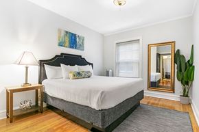 Chicago apartment for rent - a bedroom with a bed and a mirror