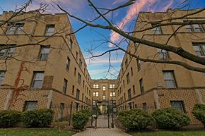 Chicago apartment for rent - a courtyard between two brick buildings with a blue sky