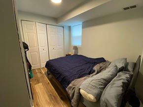 Chicago apartment for rent - A bedroom with a bed and a wardrobe.
