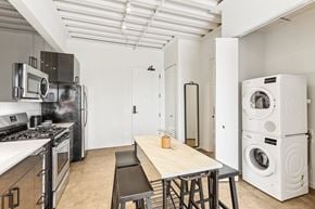 Chicago apartment for rent - A modern kitchen with a wooden table and stainless steel appliances.