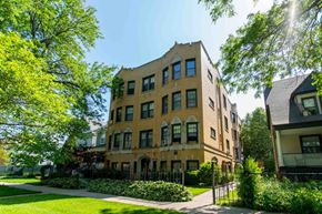 Chicago apartment for rent - a large brick building with a sidewalk in front of it