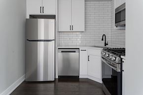 Chicago apartment for rent - A modern kitchen with a stainless steel refrigerator and oven.