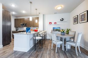 Kissimmee apartment for rent - A modern kitchen with a dining table set for four.