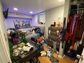 Chicago apartment for rent - A messy bedroom with a bed, wardrobe, and a TV.