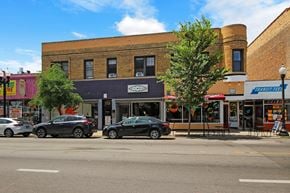 Chicago apartment for rent - a city street with cars parked in front of a brick building