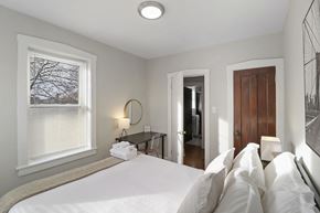 Chicago apartment for rent - a bedroom with a large bed and a window