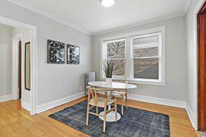 Chicago apartment for rent - a dining room with a table and chairs and a window