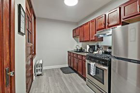 Chicago apartment for rent - a kitchen with stainless steel appliances and wooden cabinets