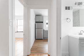 Chicago apartment for rent - A white hallway leads to a kitchen.