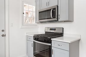 Chicago apartment for rent - A modern kitchen with a stove, oven, and microwave.
