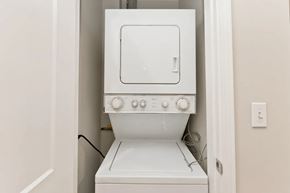 Chicago apartment for rent - A white washing machine is sitting in a small space.