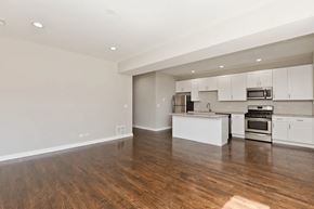Chicago apartment for rent - A kitchen with white cabinets and stainless steel appliances.