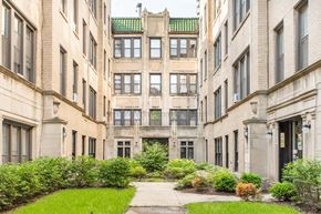 Chicago apartment for rent - A courtyard surrounded by buildings with a green roof.
