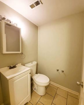 Chicago apartment for rent - A white toilet and sink in a small bathroom.