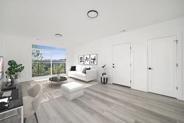Evanston apartment for rent - A modern living room with a glass table and white furniture.
