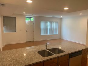 Chicago apartment for rent - an empty kitchen with a granite counter top and a sink