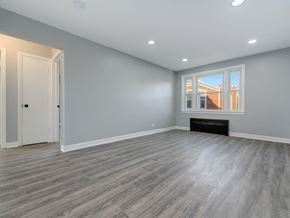 Chicago apartment for rent - A room with grey walls and a window showing a building outside.