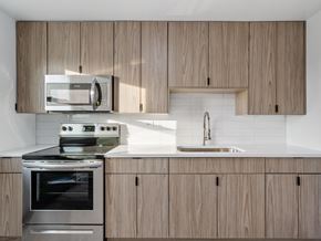Chicago apartment for rent - A modern kitchen with wooden cabinets and stainless steel appliances.