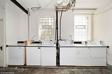 Chicago apartment for rent - A white kitchen with a sink and a window.