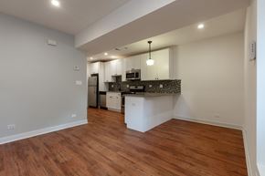 Chicago apartment for rent - A kitchen area with a white countertop and a white fridge.