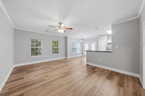 Lafayette apartment for rent - A spacious room with wooden flooring and a ceiling fan.
