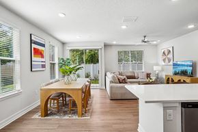 Tavares apartment for rent - A modern dining room with a wooden table and chairs.
