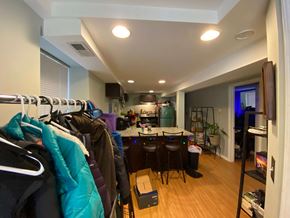 Chicago apartment for rent - A room with a row of clothes hanging on a rack.