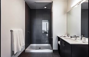 Chicago apartment for rent - a black and white bathroom with a shower and sink