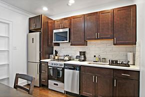 Chicago apartment for rent - A kitchen with brown cabinets and stainless steel appliances.