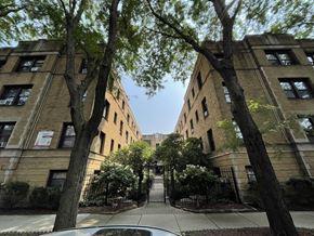 Chicago apartment for rent - the entrance to a building with trees in front of it