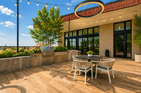Chicago apartment for rent - A patio with a table and chairs is set up outside a building.