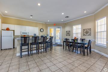 Kissimmee apartment for rent - A kitchen with a dining table and chairs.