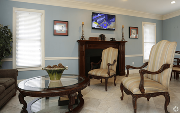 Lafayette apartment for rent - A living room with a brown coffee table and striped armchair.