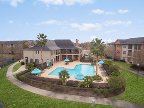Lafayette apartment for rent - A pool surrounded by a grassy area and a fence.