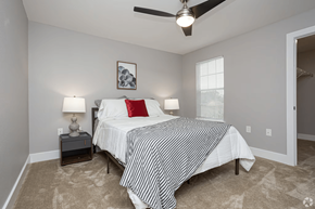 Lafayette apartment for rent - A bedroom with a bed, two lamps, and a ceiling fan.