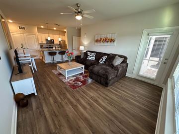 Tavares apartment for rent - A living room with a brown couch and a wooden floor.