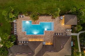 Tavares apartment for rent - A swimming pool is surrounded by a stone wall.