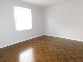 Evanston apartment for rent - A room with a wooden floor and a window letting in light.