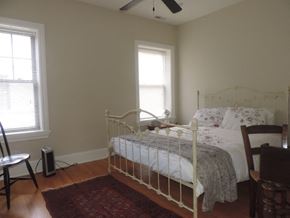 Evanston apartment for rent - a bedroom with a bed and two windows