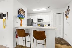 Clermont apartment for rent - A kitchen with white cabinets and a white counter top.