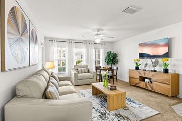 Clermont apartment for rent - A living room with a beige sofa, a coffee table, and a painting on the wall.
