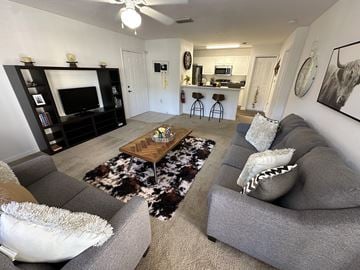 Clermont, Lake apartment for rent - A living room with a grey couch and a wooden coffee table.