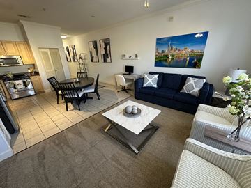 Clermont apartment for rent - A living room with a blue couch and a coffee table in the center.