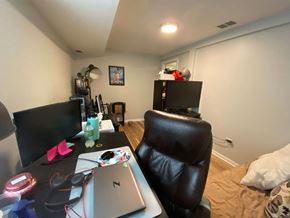 Chicago apartment for rent - A laptop is on a desk with a chair in front of it.