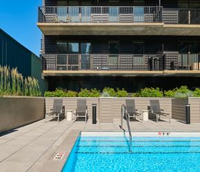 Chicago apartment for rent - A swimming pool in front of a building with a balcony.