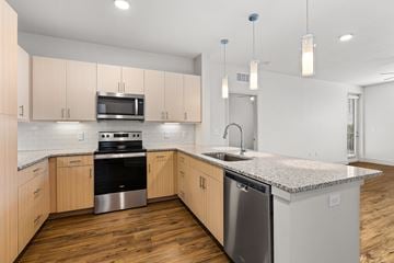 Clermont apartment for rent - A kitchen with wooden cabinets and granite countertops.